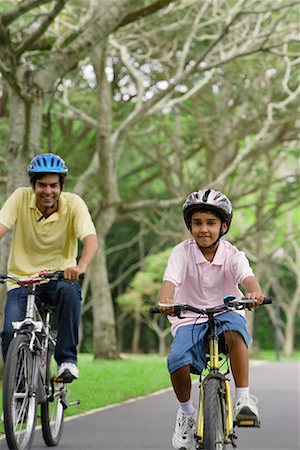 A father and son ride their bikes together Stock Photo - Premium Royalty-Free, Code: 655-01781348