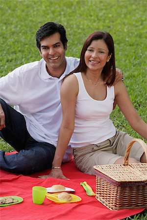 simsearch:655-01781357,k - A couple smile at the camera as they have a picnic together in the park Stock Photo - Premium Royalty-Free, Code: 655-01781368