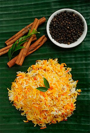 Still life of saffron rice, black pepper and cinnamon sticks Stock Photo - Premium Royalty-Free, Code: 655-01781506