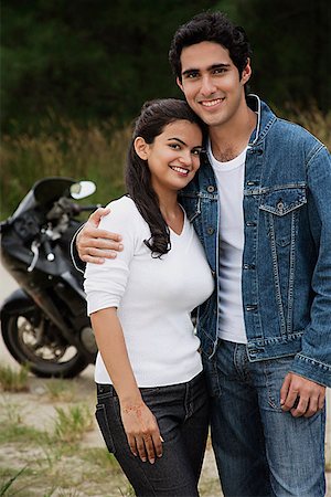pakistani - Young couple with motorbike smiling at camera Stock Photo - Premium Royalty-Free, Code: 655-01781510