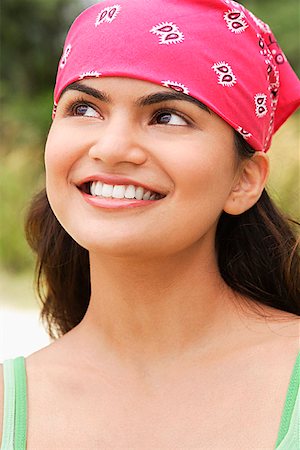 Young woman with bandana smiling at camera Stock Photo - Premium Royalty-Free, Code: 655-01781542