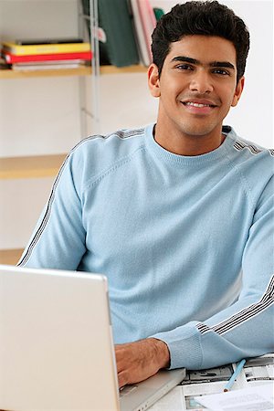 smart asian math - Young man with laptop smiling at camera Stock Photo - Premium Royalty-Free, Code: 655-01781551