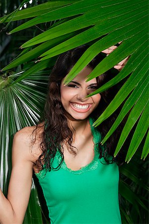 simsearch:655-03519580,k - Woman hidden by plants, smiling at camera Stock Photo - Premium Royalty-Free, Code: 655-01781605