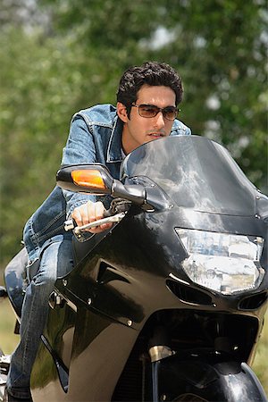 pakistani ethnicity - Young man riding motorbike Stock Photo - Premium Royalty-Free, Code: 655-01781609