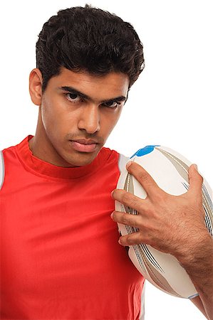 Young man with rugby looking at camera Stock Photo - Premium Royalty-Free, Code: 655-01781612