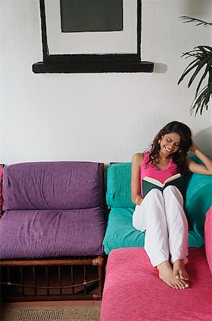 studying sofa - Woman sitting on sofa, reading a book Stock Photo - Premium Royalty-Free, Code: 655-01781707