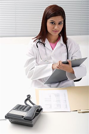 person on phone with clipboard - Doctor working on report Stock Photo - Premium Royalty-Free, Code: 655-02375783