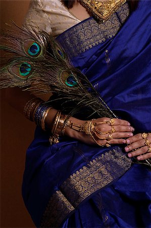 folklore - Torso of Indian woman holding peacock feathers Stock Photo - Premium Royalty-Free, Code: 655-02375866