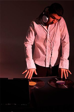 Young man working as DJ Stock Photo - Premium Royalty-Free, Code: 655-02375878