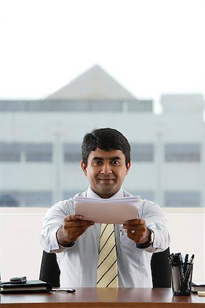 simsearch:655-03457957,k - business man handing over a stack of paper Stock Photo - Premium Royalty-Free, Code: 655-02702912