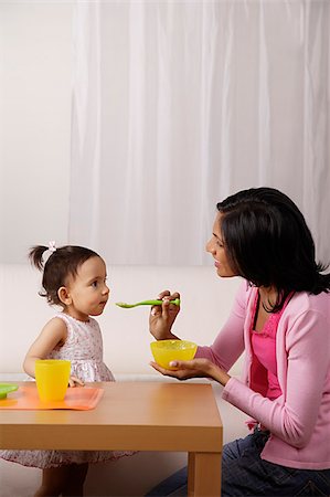 feeding asian family - woman feeding food to her baby Stock Photo - Premium Royalty-Free, Code: 655-02702960