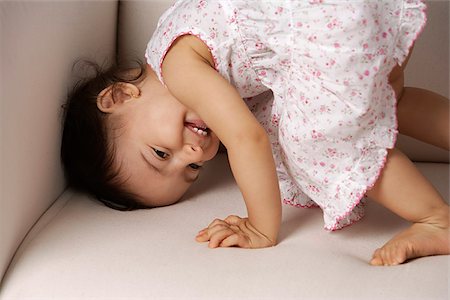eurasian - toddler playing on the couch Stock Photo - Premium Royalty-Free, Code: 655-02703035