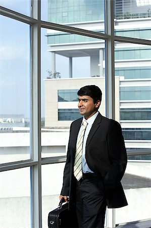 succeed - business man holding briefcase, looking out of the window Stock Photo - Premium Royalty-Free, Code: 655-02703061