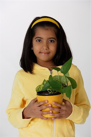 simsearch:655-02883054,k - Girl holding plant Foto de stock - Royalty Free Premium, Número: 655-02883047
