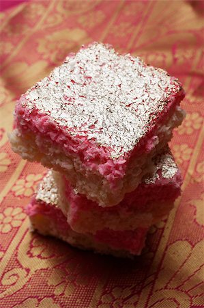 singapore food - A stack of Indian pink sweets with silver topping. Stock Photo - Premium Royalty-Free, Code: 655-03082817