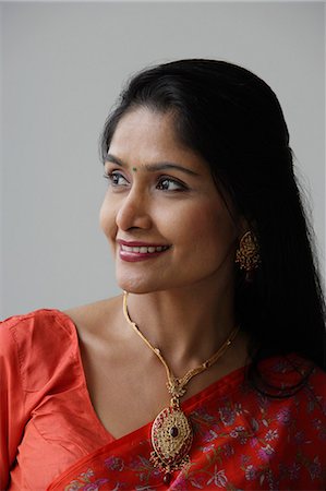 Head shot of Indian woman wearing a sari and smiling Stock Photo - Premium Royalty-Free, Code: 655-03241611