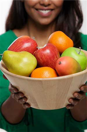 simsearch:655-03457904,k - Young woman holding a bowl of fruit Stock Photo - Premium Royalty-Free, Code: 655-03457892