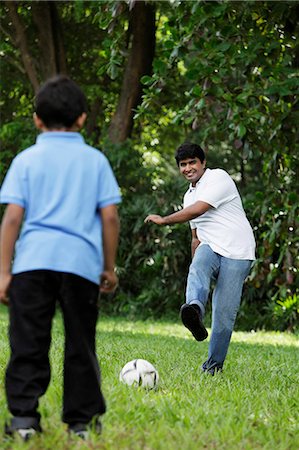 soccer dad - Father kicking ball to son Stock Photo - Premium Royalty-Free, Code: 655-03458019