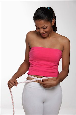 simsearch:695-05773352,k - Young woman measuring herself with tape measure and smiling Foto de stock - Sin royalties Premium, Código: 655-03458023