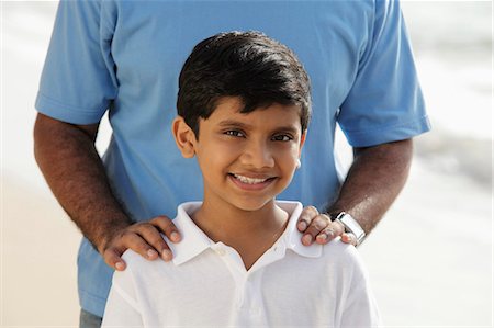 father son two indian - Cropped shot of father's hands on smiling son's shoulders Stock Photo - Premium Royalty-Free, Code: 655-03458033