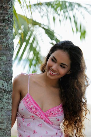 simsearch:655-03519580,k - young woman smiling with long hair next to coconut tree Stock Photo - Premium Royalty-Free, Code: 655-03519575