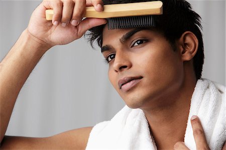 prep - head shot of young man brushing his hair Foto de stock - Sin royalties Premium, Código: 655-03519610