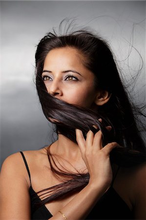 head shot of woman with hair blowing around her face Stock Photo - Premium Royalty-Free, Code: 655-03519662
