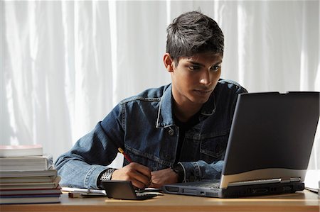 simsearch:655-02375870,k - young man looking at computer and studying Stock Photo - Premium Royalty-Free, Code: 655-03519670