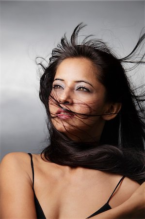 head shot of woman with hair blowing around her face Stock Photo - Premium Royalty-Free, Code: 655-03519687