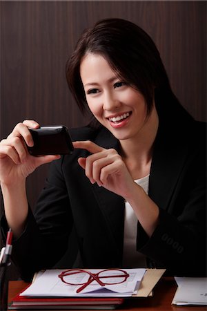 simsearch:656-04926450,k - Young woman looking at phone Stock Photo - Premium Royalty-Free, Code: 656-04926464