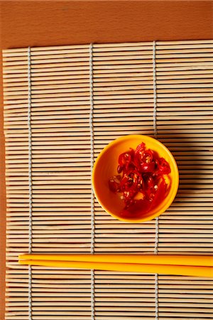 food on mat - Small bowl of red chillies and chopsticks. Stock Photo - Premium Royalty-Free, Code: 656-04926513
