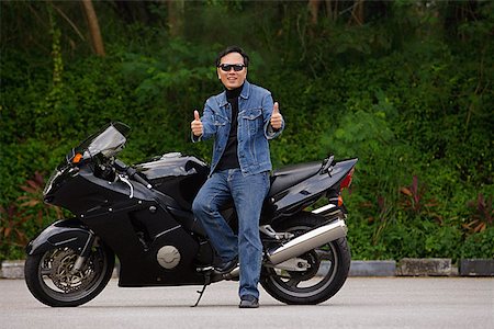 stylish older man portrait - Man sitting on motorcycle, giving thumbs up Stock Photo - Premium Royalty-Free, Code: 656-01765307