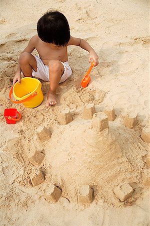 simsearch:841-03507749,k - Young boy on beach building sand castle Stock Photo - Premium Royalty-Free, Code: 656-01765313