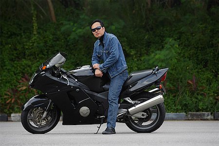 Mature man sitting on motorcycle, wearing sunglasses Stock Photo - Premium Royalty-Free, Code: 656-01765352