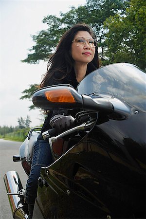 Mature woman riding motorcycle, wearing sunglasses Stock Photo - Premium Royalty-Free, Code: 656-01765364