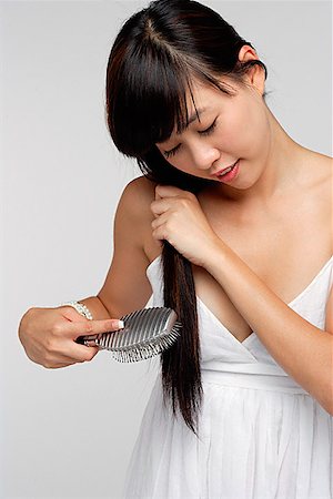 simsearch:656-01765511,k - Young woman wearing white dress and brushing hair Stock Photo - Premium Royalty-Free, Code: 656-01765525