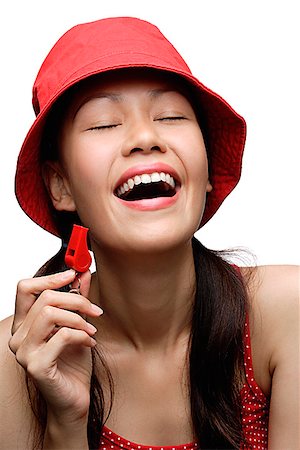simsearch:6109-06781751,k - Jeune femme chapeau rouge et sifflet holding, rire Photographie de stock - Premium Libres de Droits, Code: 656-01765528