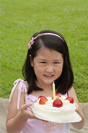 fruit birthday cake with candles - Girl holding birthday cake with one candle Stock Photo - Premium Royalty-Free, Code: 656-01765568