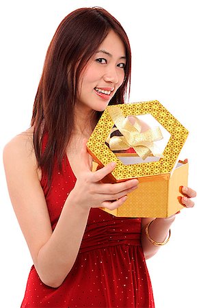 simsearch:656-01765511,k - Young woman opening present, and looking at camera Stock Photo - Premium Royalty-Free, Code: 656-01765574