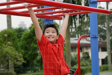 struggle to reach - Boy using the jungle gym at playground Stock Photo - Premium Royalty-Free, Code: 656-01765575