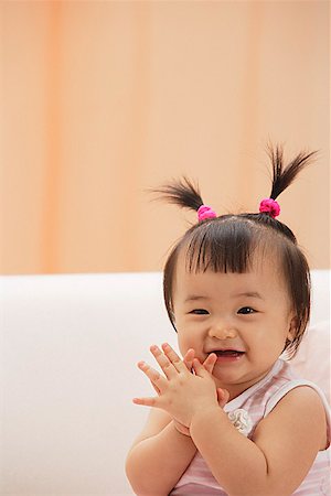 Baby Girl clapping hands and laughing, looking at camera Stock Photo - Premium Royalty-Free, Code: 656-01765578