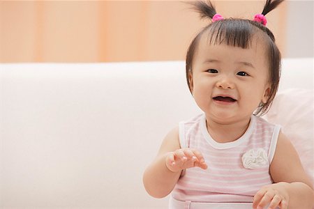Baby girl laughing and smiling at camera Stock Photo - Premium Royalty-Free, Code: 656-01765595
