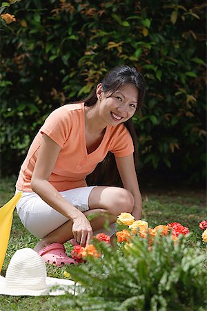 simsearch:649-08702075,k - Woman tending to flower bed in garden Stock Photo - Premium Royalty-Free, Code: 656-01765696