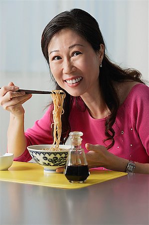 simsearch:649-03291674,k - Mature woman eating a bowl of noodles Stock Photo - Premium Royalty-Free, Code: 656-01765767