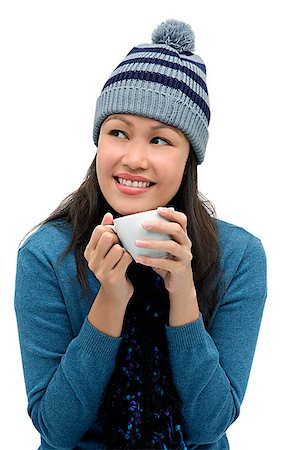 Young woman wearing winter hat and scarf and holding cup Stock Photo - Premium Royalty-Free, Code: 656-01765790