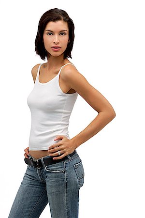 Young woman looking at camera with hands on hips Stock Photo - Premium Royalty-Free, Code: 656-01765836