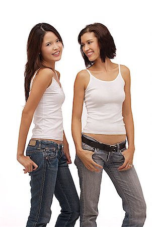 simsearch:656-01765511,k - Two young women standing together smiling Stock Photo - Premium Royalty-Free, Code: 656-01765875