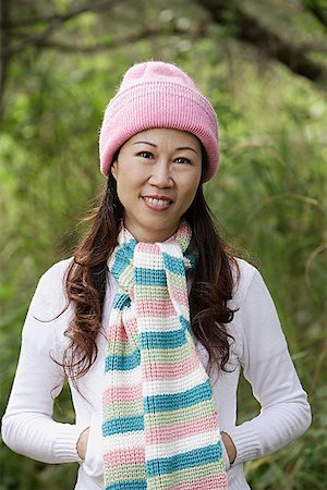 simsearch:673-02138920,k - Woman wearing hat and scarf outdoors in nature, smiling at camera Stock Photo - Premium Royalty-Free, Code: 656-01765903