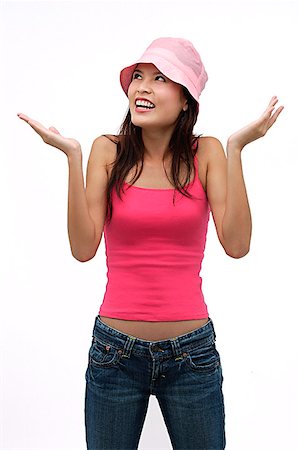 silhouette of person questioning - Young woman wearing pink hat with arms raised up Stock Photo - Premium Royalty-Free, Code: 656-01765961