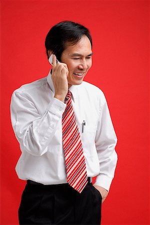 simsearch:656-01766020,k - A man smiles as he talks on a cellphone Foto de stock - Sin royalties Premium, Código: 656-01766232